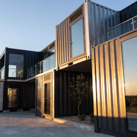 Stacked modified shipping containers forming a multi-level building